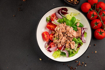 Tuna salad canned fish, tomato, green leaf salad vegetable dish natural tasty snack fresh gourmet food background on the table rustic top view copy space keto paleo diet vegetarian food pescetarian