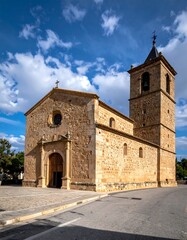 Stone church with a tall tower and a blue sky