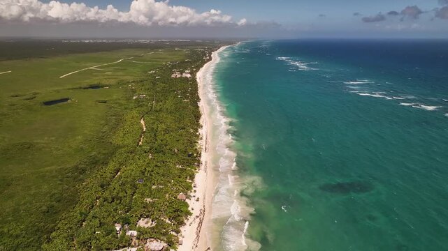 Aerial 4K drone view of Tulum coastline and Caribbean beach Mexico - tropical sea waves and Sian Kaan biosphere reserve