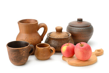 Traditional Earthenware Pottery with Floral Motifs and Fresh Apples Arranged on White Background for Culinary and Cultural Presentation
