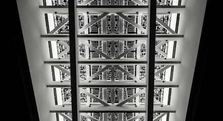 Abstract view of a white structure with geometric patterns illuminated from below in monochrome style