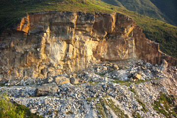 A sprawling marble quarry in the mountainous region of Buner, Khyber Pakhtunkhwa, Pakistan, showing large, rough-cut blocks of dimension stone 