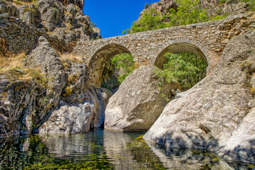 The old Ponte di l'Accia stone bridge on the Scala di Santa Regina hiking trail looks like a face...