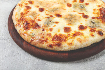 Freshly baked cheese pizza, white pizza, on a wooden plate, homemade, no people,