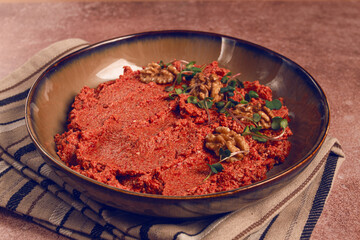 Mahammara red pepper sauce, with walnuts, and sprigs of fresh microgreens, homemade, no people,