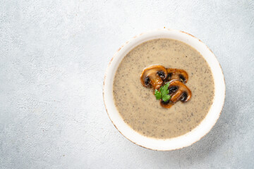 Mushroom soup puree on white kitchen table.