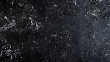Dark textured surface with rough, weathered, and scratched details.