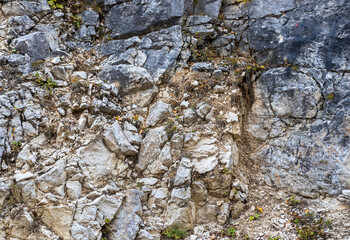 A fragment of limestone rock on a section of a stone canyon on an autumn day