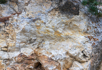 A fragment of limestone rock on a section of a stone canyon on an autumn day
