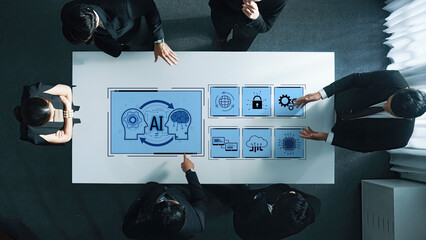 A diverse business team engages in a discussion about artificial intelligence strategies illustrated with digital icons on a sleek office table. Trope