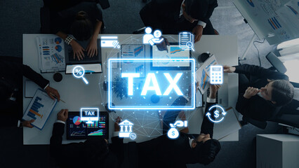 Professionals engage in a collaborative finance meeting focused on tax planning. Digital symbols enhance the conversation, emphasizing data-driven strategies in a modern office setting. Trope