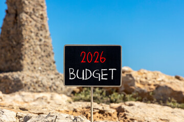 2026 Budget symbol. Concept words 2026 Budget on beautiful black blackboard. Beautiful stone and blue sky background. Business and 2026 budget concept. Copy space.