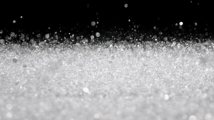 Abstract macro image of a cluster of glistening, white granules floating in the air against black backdrop - Powered by Adobe