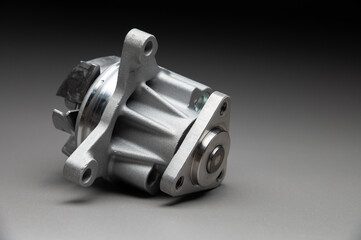 New parts for engine cooling system repair. Water pump for pumping coolant within the engine.