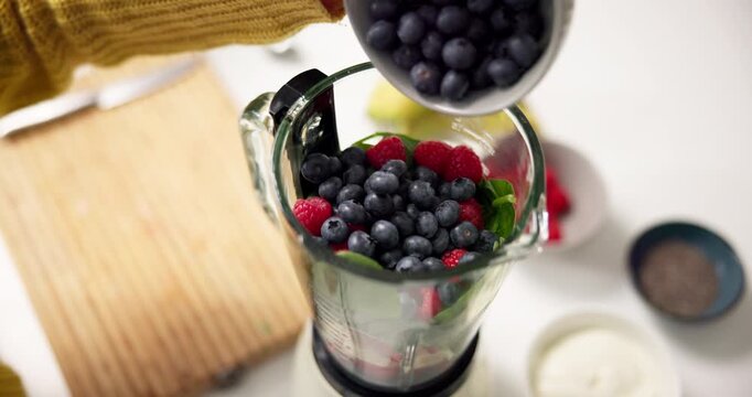 Hands, blender and blueberry in kitchen for smoothie, meal prep and process for healthy drink. Person, chef and organic ingredients for diet, nutrition or above for weight loss with wellness at house