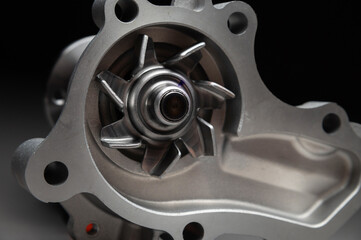 New parts for engine cooling system repair. Water pump for pumping coolant within the engine.