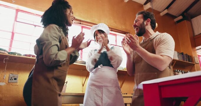 Cooking, hands stack and people in kitchen, below and happiness with gourmet cuisine. Man, women and chef with growth, smile and learning with celebration, success and culinary skills with goals