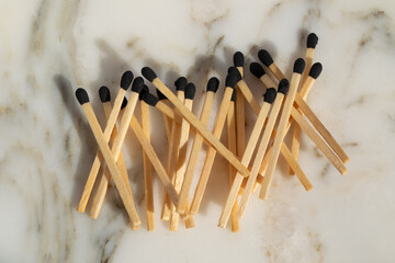 safety matches with black tip on a white marble background