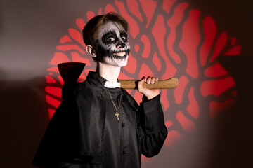 a young guy dressed up in a Halloween costume with an axe.
