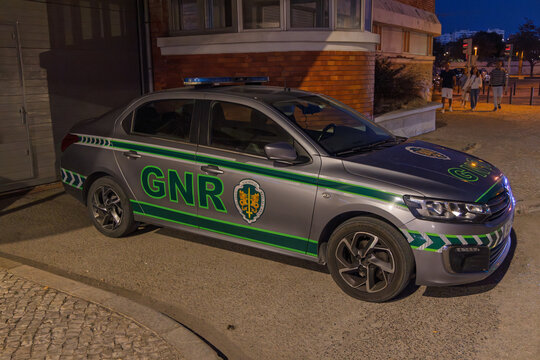 A GNR (Guarda Nacional Republicana) patrol car is parked at dusk in Portugal. The vehicle features its distinctive green and gray livery and emblem. Setubal, Portugal. 20 August 2025.
