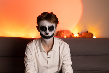 man with skeleton face paint, black and white design, on his face