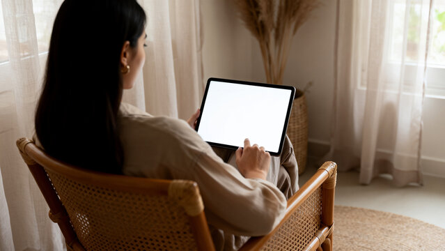 Woman using tablet in cozy room