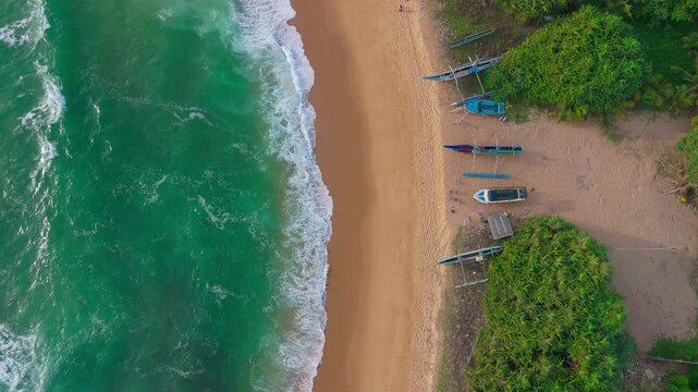 Tropical Evening Drone Shot of Fishing Boats and Sea Waves Along Sandy Coastline