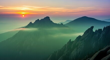 Majestic Mountain Sunrise Through Wispy Foggy Clouds