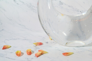 Cluster of orange, red, and pink dahlias in clear vase

