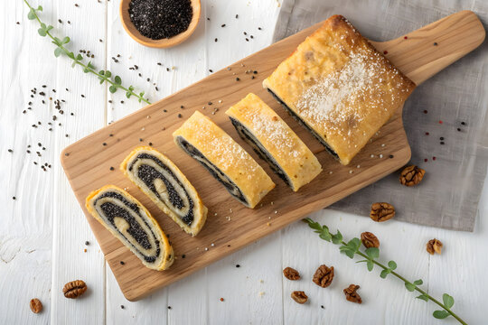 Delicious poppy seed roll sliced on a wooden board