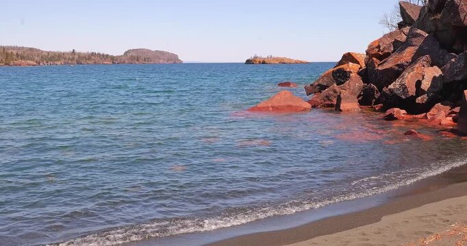 The rocky North Shore of beautiful Lake Superior, Gichi Gami, in Silver Bay, Minnesota, as seen from Black Beach on a sunny spring day.