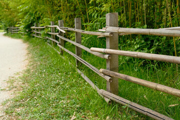 An old wooden fence at the edge of the road stretches into the distance.