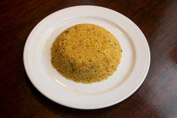 Bhuna Khichuri or Spiced Rice and Lentil Comfort Food on a White Plate side view of bangladeshi food