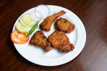Loitta Mach Fry Bombay Duck Fish Fritters served with fresh salad and Tomato in plate side view of bangladeshi food