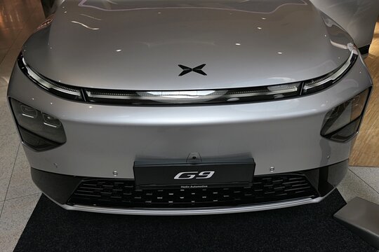 Front mask of modern chinese battery electric mid-sized crossover SUV car XPeng P9, silver metallic chassis color, displayed on car expo in Bory Mall Bratislava, Slovakia, september 2025