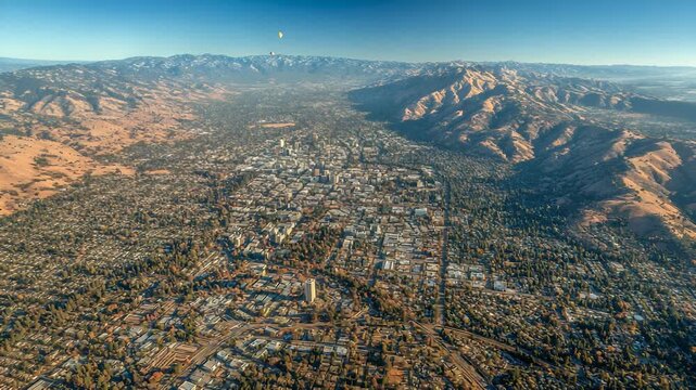 Aerial View of San Jose, California, with Diablo Range Mountains and Clear Blue Sky, Featuring Urban Landscape and Residential Neighborhoods