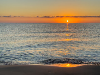 Minimalist sunset over the Aegean Sea at Thassos Island, Greece. Calm horizon, warm red sky and open water. Ideal for: travel marketing, relaxation, background use, copy space.