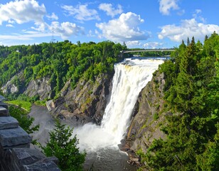 Obraz premium Stunning Waterfall Cascading Down Rocky Cliffs Under a Bright Blue Sky