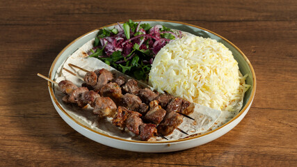 Lamb kebab with rice and lavash on plate