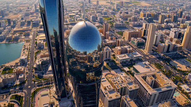 Aerial view of futuristic skyscrapers in a bustling cityscape, capturing urban architecture in a dynamic video style from a high angle.