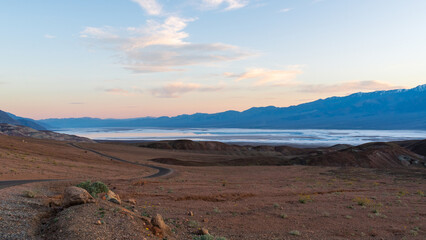 Sunset at Badwater Basin with Lake Manly Reflections and Curving Road, Death Valley National Park