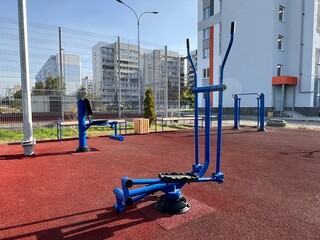 An outdoor fitness and training area with exercise equipment in a modern residential courtyard