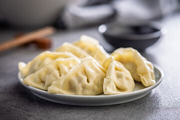Traditional japanese gyoza dumplings and soy sauce on kitchen table.