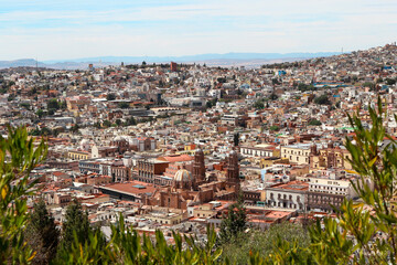 Naklejka premium Aerial view over Zacatecas city in Mexico white sightseeing on a partly sunny afternoon