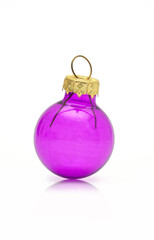 Purple glass Christmas ornament ball with golden cap isolated on white background.
