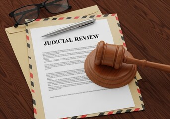 Judicial review document with gavel and glasses on a wooden table