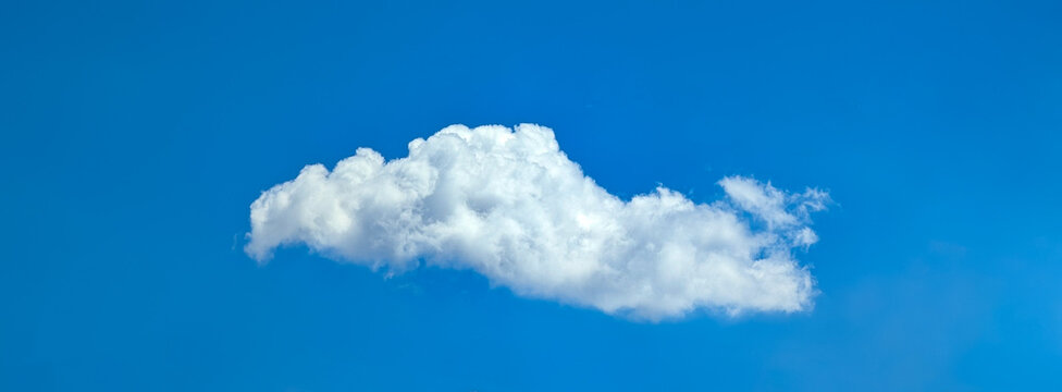 Beautiful cloudscape of nature single white cloud on blue sky background in daytime. Fabulous swirling water vapors. Multi-tiered clouds of steam.