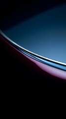 Sleek curved metallic edge with blue and pink light reflections.