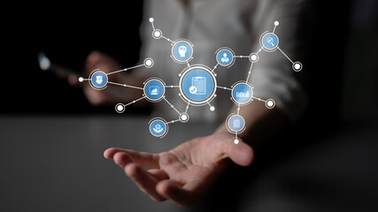 Fototapeta premium A person interacts with digital icons in a modern setting, symbolizing the fusion of technology and communication in the digital age and inspiring innovation. Tessel