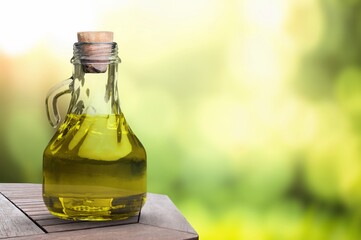 Green fresh olive oil in glass bottle